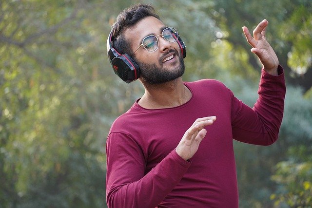 man listening to music with headsets